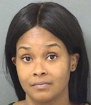Mugshot of a woman with long dark hair and a neutral expression