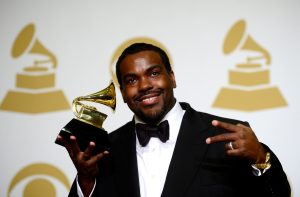 Rodney Jerkins smiles and holds a GRAMMY Award