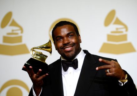 Rodney Jerkins smiles and holds a GRAMMY Award