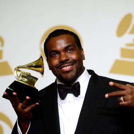 Rodney Jerkins smiles and holds a GRAMMY Award