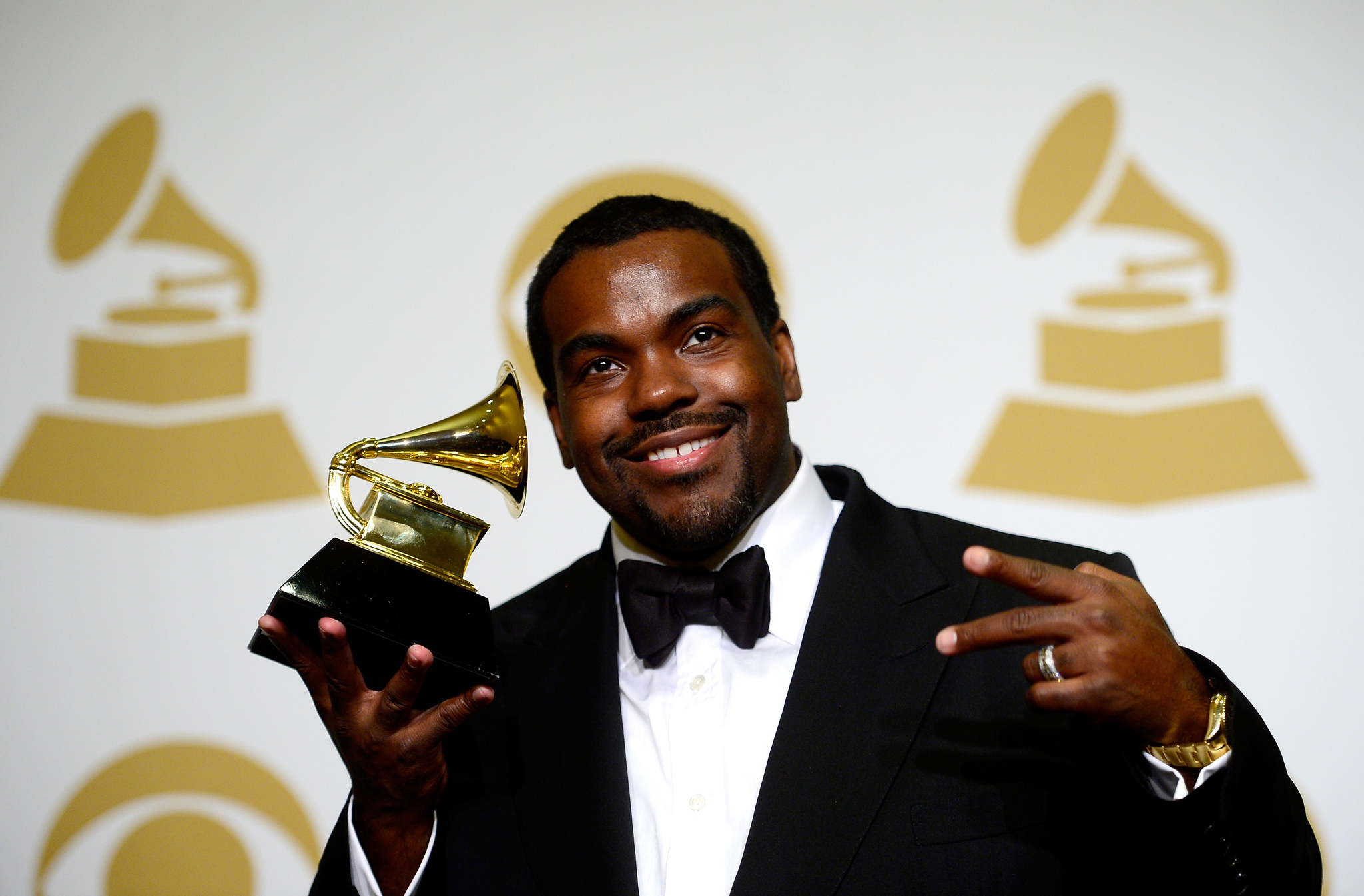 Rodney Jerkins smiles and holds a GRAMMY Award