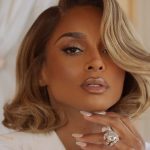 Ciara with styled blonde hair and glamorous makeup, showcasing a large diamond ring