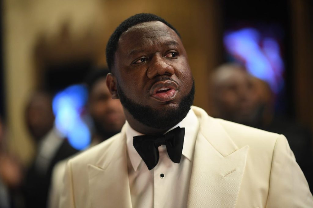 Pierre "P" Thomas wearing a cream tuxedo jacket and black bow tie, looking off to the side