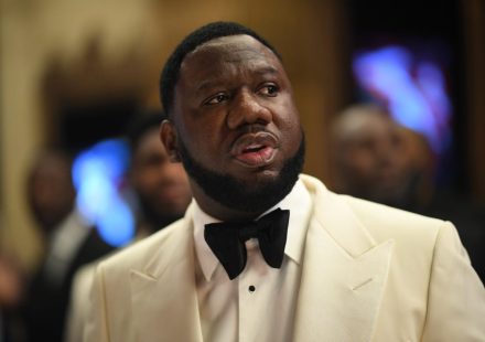 Pierre "P" Thomas wearing a cream tuxedo jacket and black bow tie, looking off to the side